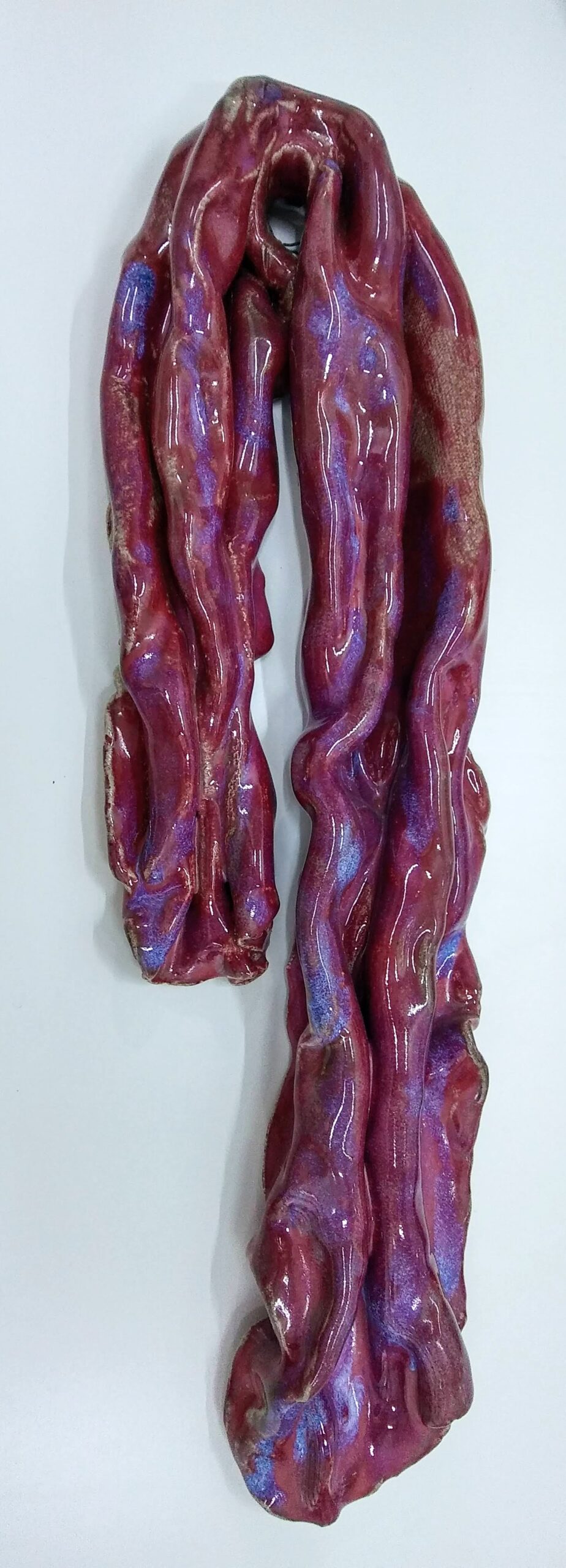 Ceramic art sculpture in the shape of a red scarf